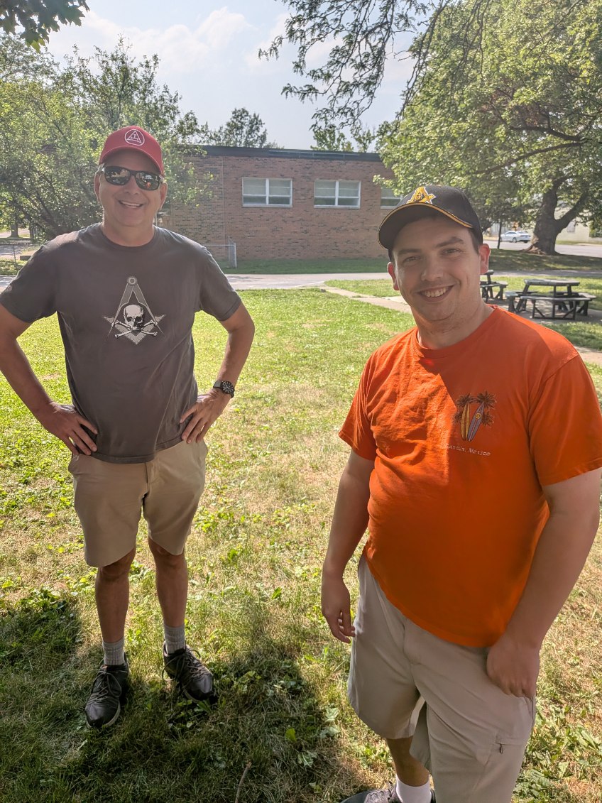 Brothers of West Gate Lodge sharing fellowship outdoors at a community gathering