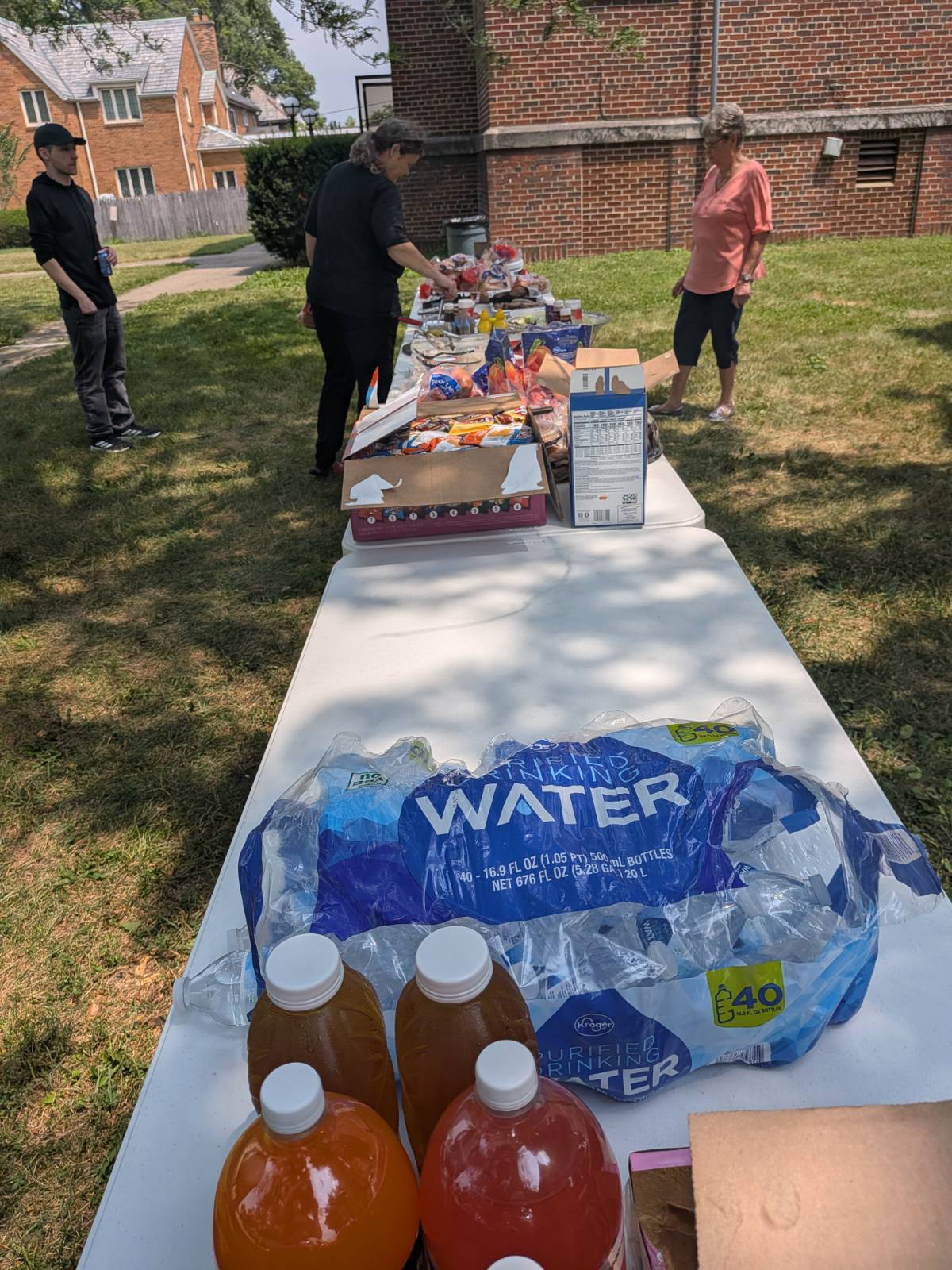 A brother preparing a plate at the community cookout